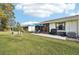 Private backyard with patio, grill, and lawn at 6796 Gasparilla Pines Blvd # 62, Englewood, FL 34224