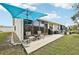 Private backyard with patio, grill, and lawn at 6796 Gasparilla Pines Blvd # 62, Englewood, FL 34224