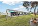 Private backyard with patio, grill, and lawn at 6796 Gasparilla Pines Blvd # 62, Englewood, FL 34224