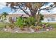 Landscaped backyard with lush tropical plants and a large tree at 6796 Gasparilla Pines Blvd # 62, Englewood, FL 34224