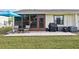 Private backyard with patio, grill, and lawn at 6796 Gasparilla Pines Blvd # 62, Englewood, FL 34224