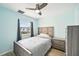 Light and airy bedroom with double bed and dresser at 6796 Gasparilla Pines Blvd # 62, Englewood, FL 34224