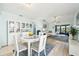 Bright dining area with a round glass table and white chairs at 6796 Gasparilla Pines Blvd # 62, Englewood, FL 34224