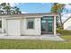 Front view of a single-story house with a grassy lawn at 6796 Gasparilla Pines Blvd # 62, Englewood, FL 34224