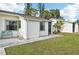 House exterior showcasing a walkway and blue bench at 6796 Gasparilla Pines Blvd # 62, Englewood, FL 34224
