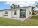 Light-colored house with a brown door and a small patio at 6796 Gasparilla Pines Blvd # 62, Englewood, FL 34224