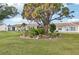 Rear view of the property showing a well-maintained building and garden at 6796 Gasparilla Pines Blvd # 62, Englewood, FL 34224