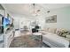 Open living space with a sectional sofa and a view into the dining area at 6796 Gasparilla Pines Blvd # 62, Englewood, FL 34224
