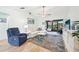 Living room with light walls, comfortable furniture, and a large TV at 6796 Gasparilla Pines Blvd # 62, Englewood, FL 34224