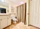 Well-lit bathroom with shower, toilet and a vanity at 7339 Cameo Cir, North Port, FL 34291