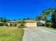 Front view of the house with driveway and covered RV parking at 7339 Cameo Cir, North Port, FL 34291