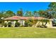 Single-story home with a red tile roof, landscaped yard, and attached garage at 7339 Cameo Cir, North Port, FL 34291