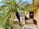 Inviting front porch with a palm tree and brick pavers at 7339 Cameo Cir, North Port, FL 34291