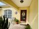 Front entrance with a red door and potted plants at 7339 Cameo Cir, North Port, FL 34291