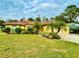 Single story home with a well maintained lawn and landscaping at 7339 Cameo Cir, North Port, FL 34291