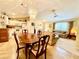 Bright kitchen with white cabinets, tile floors, and adjacent dining area at 7339 Cameo Cir, North Port, FL 34291