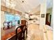 Open concept kitchen and dining area with white cabinets and view of patio at 7339 Cameo Cir, North Port, FL 34291