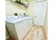 Bright laundry room with washer, dryer and shelving at 7339 Cameo Cir, North Port, FL 34291