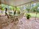 Covered patio with outdoor furniture and lush landscaping at 7339 Cameo Cir, North Port, FL 34291