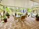 Relaxing screened patio with brick pavers and outdoor furniture at 7339 Cameo Cir, North Port, FL 34291