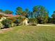Landscaped yard with lush green grass and mature trees at 7339 Cameo Cir, North Port, FL 34291