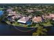 An aerial view shows a home with a pool in a peaceful, secluded setting at 75 Cayman Isles Blvd, Englewood, FL 34223