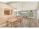 Bright dining room with wood-look floors and view into kitchen at 784 Sarabay Rd # 18, Osprey, FL 34229