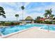 Community pool with patio furniture and a tiki hut at 784 Sarabay Rd # 18, Osprey, FL 34229