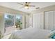 Bright bedroom with white sliding doors leading to a patio at 784 Sarabay Rd # 18, Osprey, FL 34229