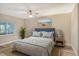 Inviting bedroom offers a tranquil setting with beach artwork and serene water views at 784 Sarabay Rd # 18, Osprey, FL 34229