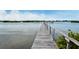 Long wooden dock extending into the water at 784 Sarabay Rd # 18, Osprey, FL 34229
