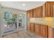Charming kitchen showcases warm wood cabinetry and an adjacent outdoor patio through sliding glass doors at 784 Sarabay Rd # 18, Osprey, FL 34229