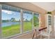 Bright living room with floor-to-ceiling windows offering a picturesque view of a fountain at 784 Sarabay Rd # 18, Osprey, FL 34229
