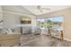 Sunlit living room with hardwood flooring, a view, decor, and comfortable seating at 784 Sarabay Rd # 18, Osprey, FL 34229