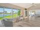 Inviting living room with floor-to-ceiling windows that offers a tranquil view and ample natural light at 784 Sarabay Rd # 18, Osprey, FL 34229