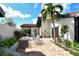 Cozy brick patio with seating area, lush landscaping, and privacy wall perfect for outdoor relaxation at 784 Sarabay Rd # 18, Osprey, FL 34229