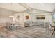 Open concept dining area with light wood table and chairs, adjacent to kitchen at 784 Sarabay Rd # 18, Osprey, FL 34229