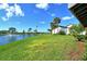 Waterfront backyard with lush landscaping and lake view at 784 Sarabay Rd # 18, Osprey, FL 34229