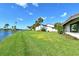 Waterfront backyard with lush landscaping and lake view at 784 Sarabay Rd # 18, Osprey, FL 34229