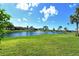 Waterfront backyard with fountain and lush landscaping at 784 Sarabay Rd # 18, Osprey, FL 34229