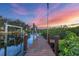 Wooden dock at sunset over calm water at 8065 Weyers Ct, Englewood, FL 34224