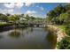 Picturesque pond with bridge and lush landscaping at 815 Montrose Dr # 103, Venice, FL 34293
