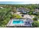 An aerial view shows the community pool and beautiful residential buildings with well-maintained landscaping at 815 Montrose Dr # 103, Venice, FL 34293
