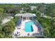 A community pool is highlighted in this aerial view of homes with lush tropical landscaping at 815 Montrose Dr # 103, Venice, FL 34293