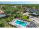 Aerial view of a sparkling pool, meticulously landscaped grounds, and charming residential buildings at 815 Montrose Dr # 103, Venice, FL 34293