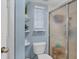 Clean bathroom with a glass door shower, white toilet, and decorative shelving at 815 Montrose Dr # 103, Venice, FL 34293
