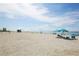 Scenic beach view with blue sky, turquoise water, and people enjoying the sun at 815 Montrose Dr # 103, Venice, FL 34293
