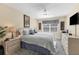 Cozy bedroom featuring a comfortable queen-sized bed, soft lighting, and neutral decor at 815 Montrose Dr # 103, Venice, FL 34293