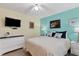 Bedroom featuring a TV, dresser and queen bed with seaside decor at 815 Montrose Dr # 103, Venice, FL 34293