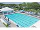 Large community pool with lounge chairs, umbrellas, and a pool house at 815 Montrose Dr # 103, Venice, FL 34293
